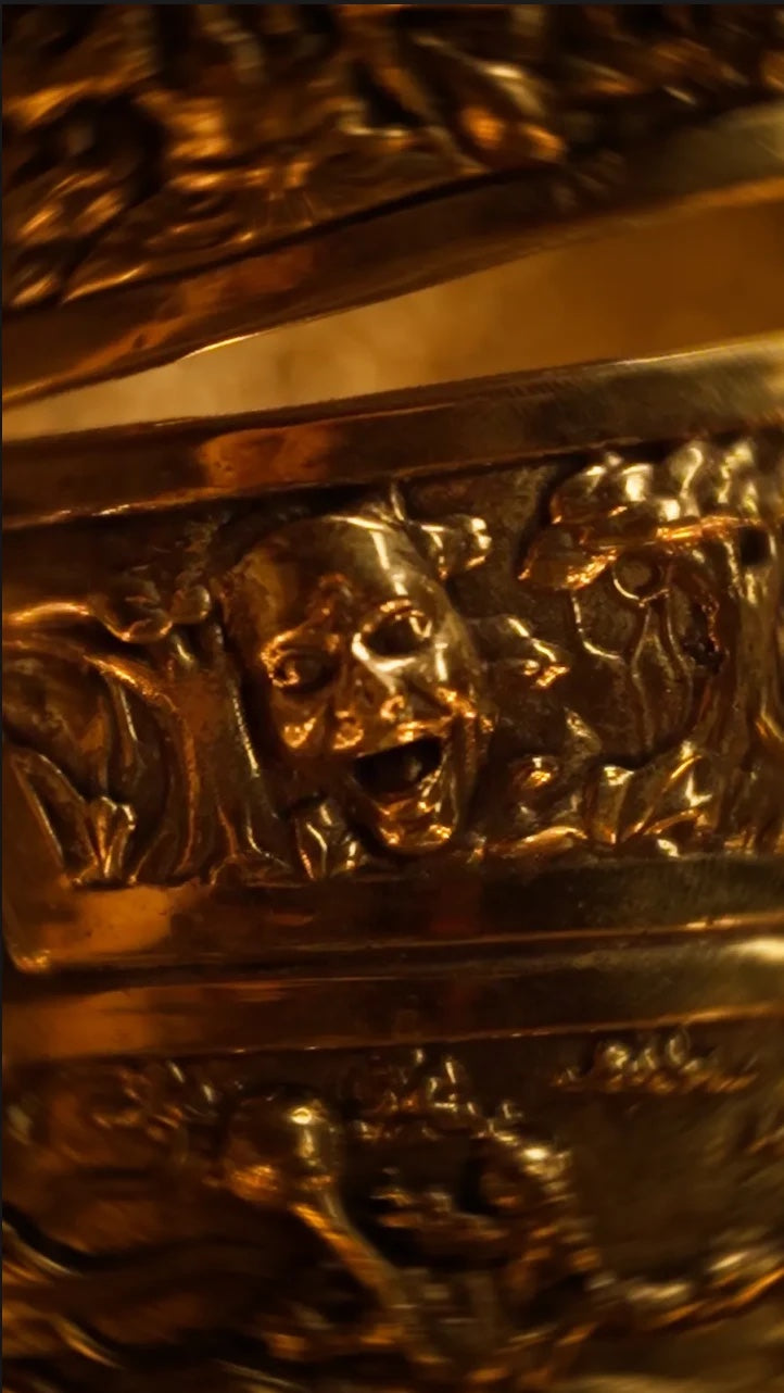 Surpanakha's anguished face in the lamp's embossed relief